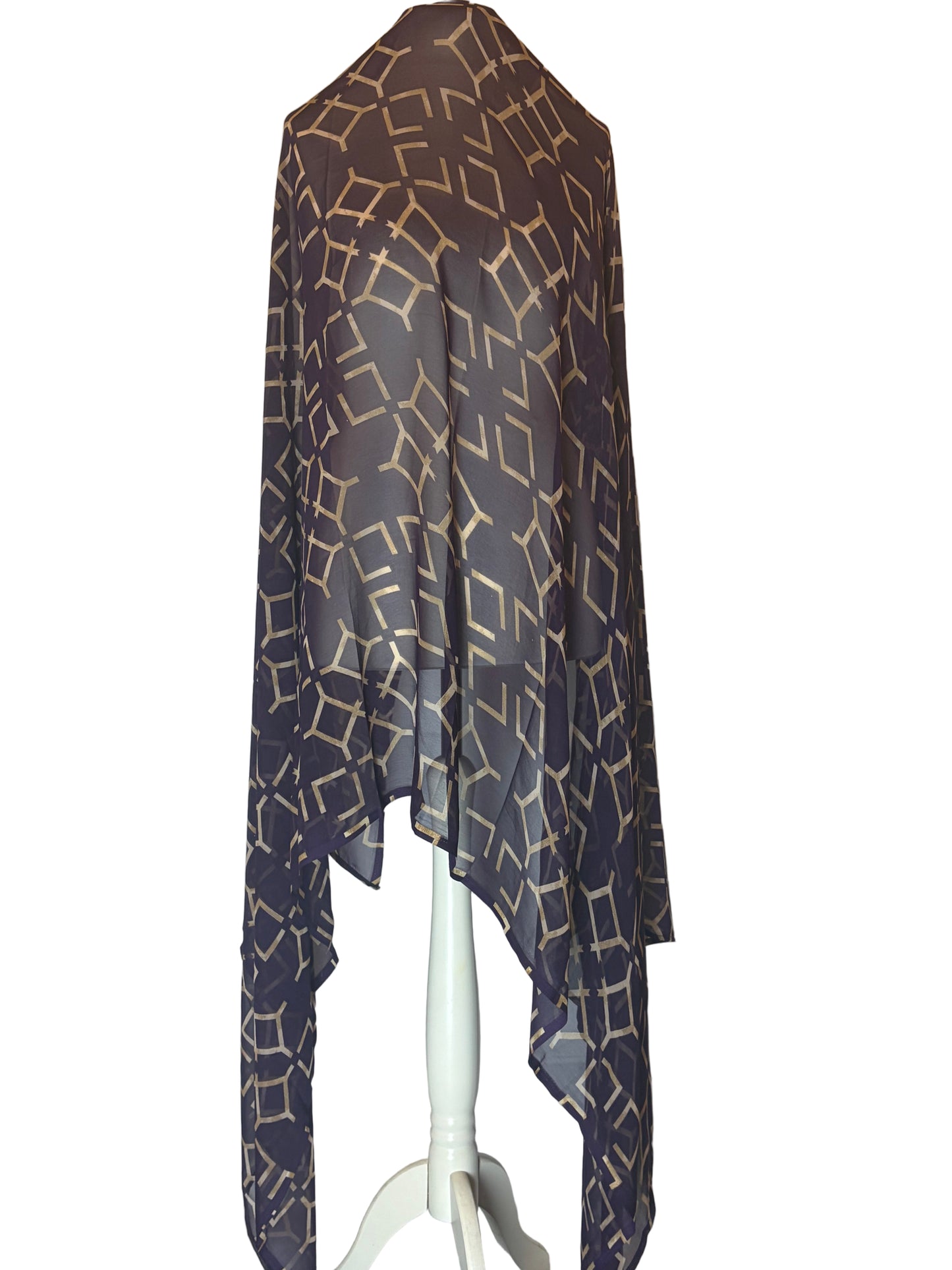 Dark patterned scarf on a white stand against a white background