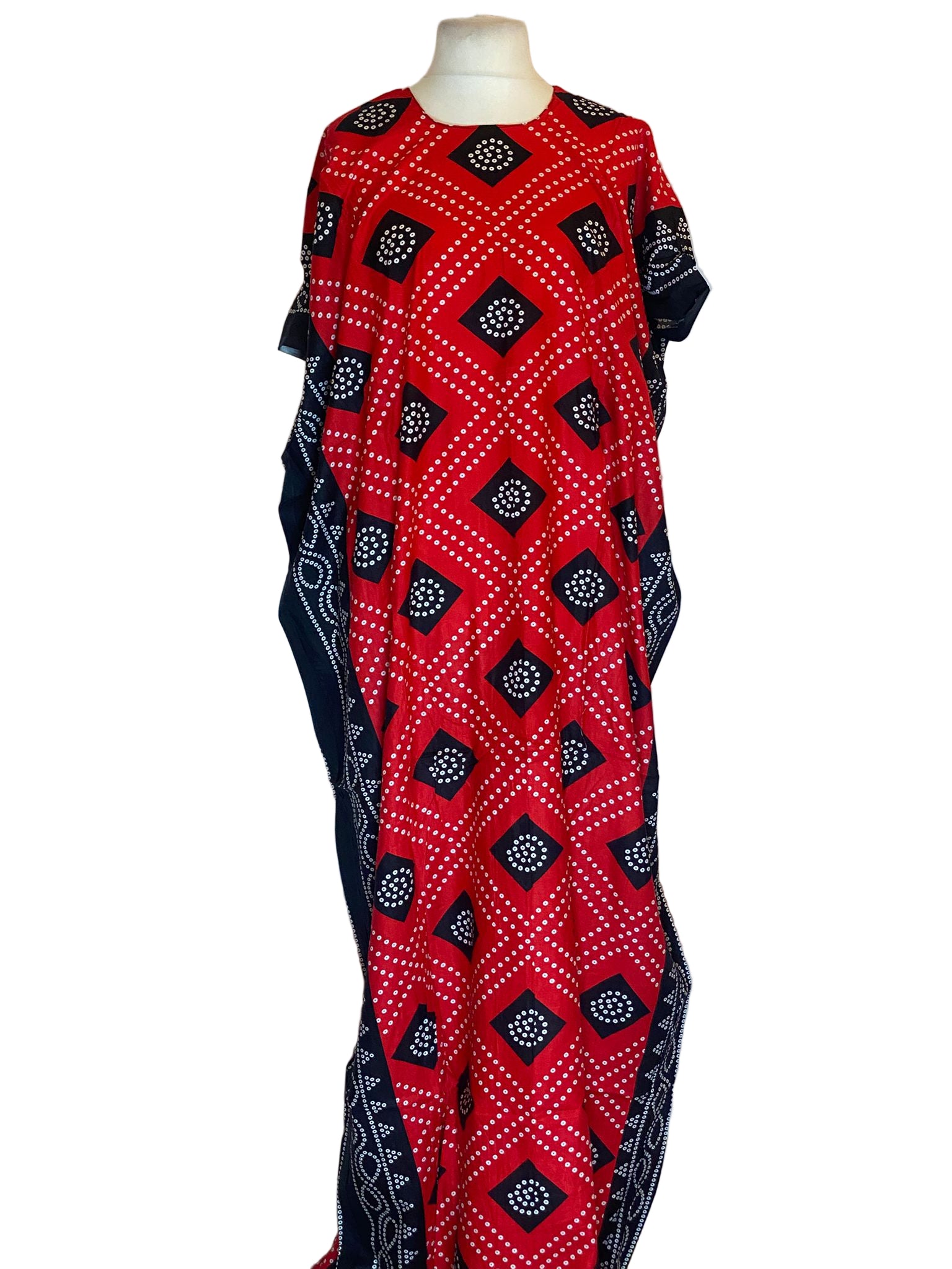 Red and black patterned somali Baati on a mannequin against a white background