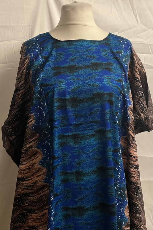 Blue and brown patterned Somali baati dress on a mannequin against a white background