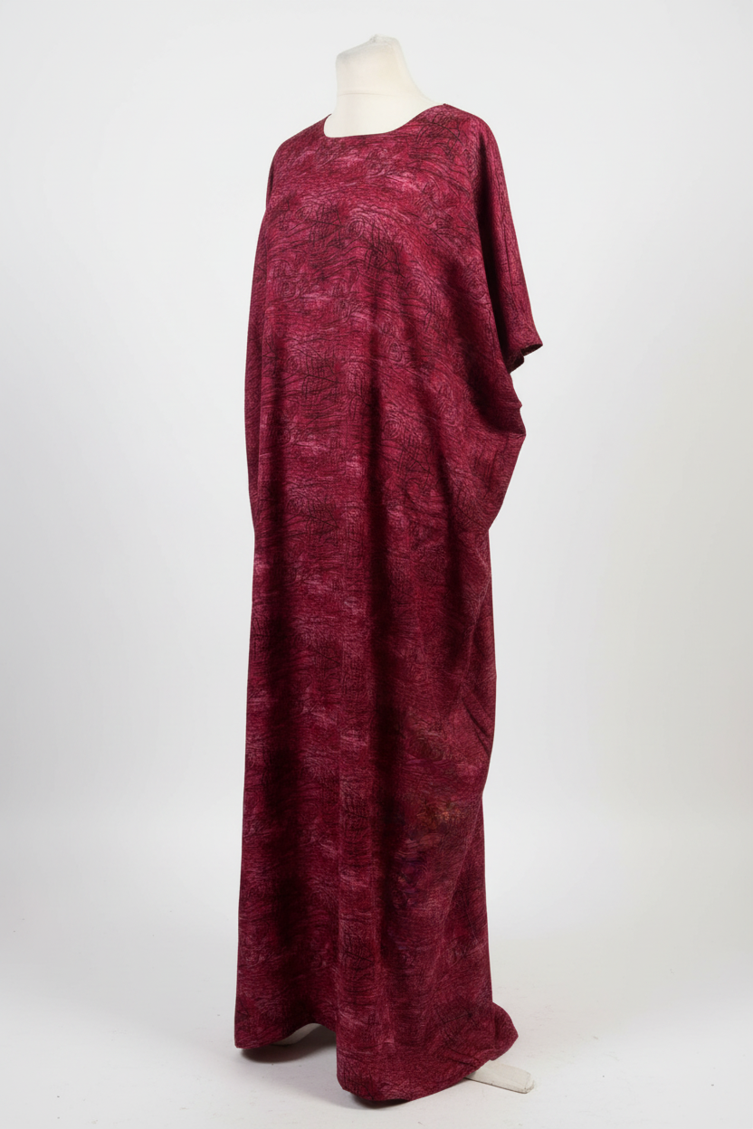Maroon Somali baati dress on a mannequin against a white background