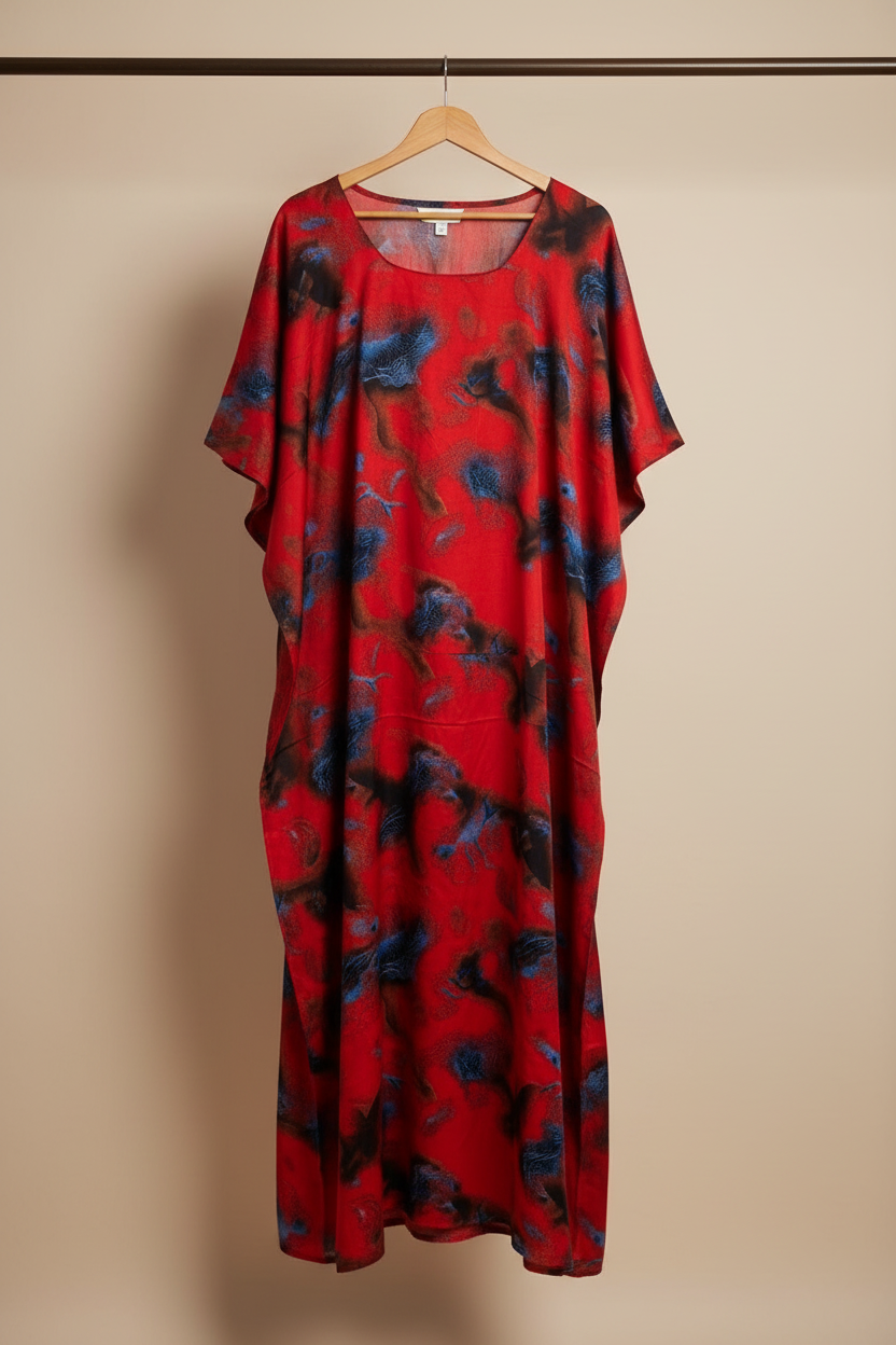 Somali Red baati dress with blue floral pattern on a hanger against a beige background