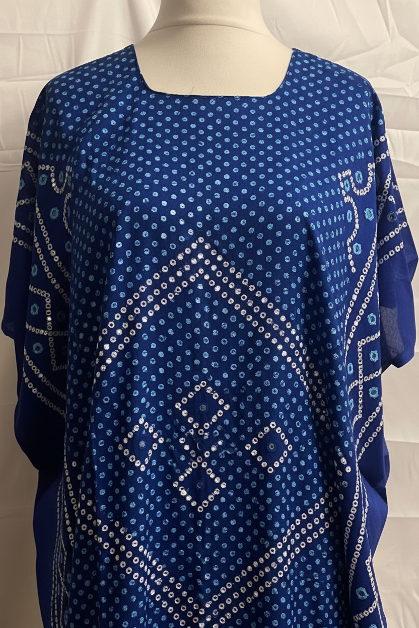 Blue patterned Somali baati on a mannequin against a white tiled wall.