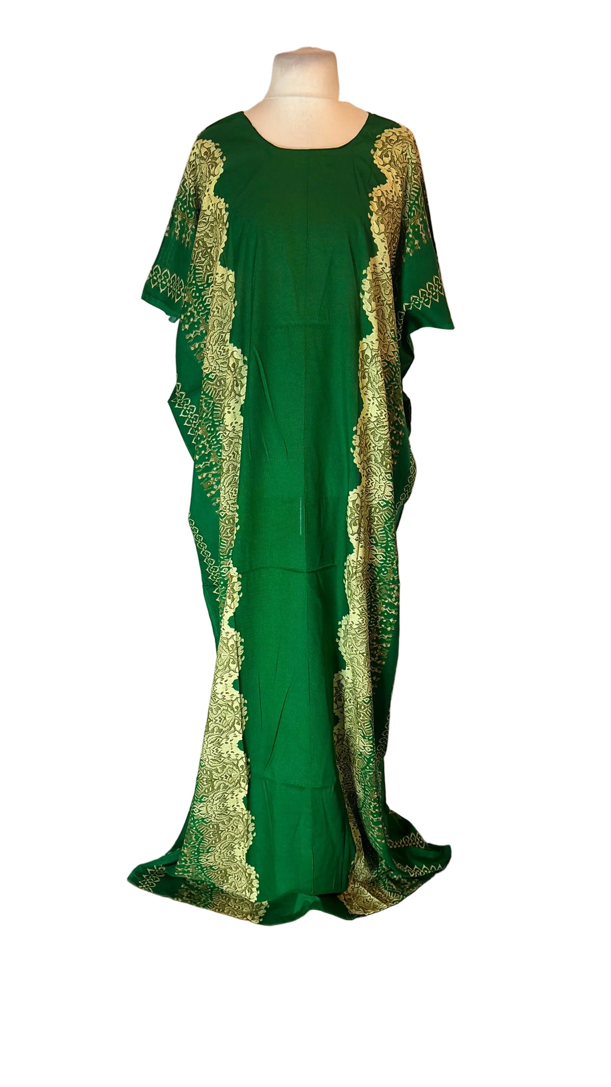 A green Somali Baati dress with gold lace trim displayed on a mannequin in front of a white fabric backdrop.