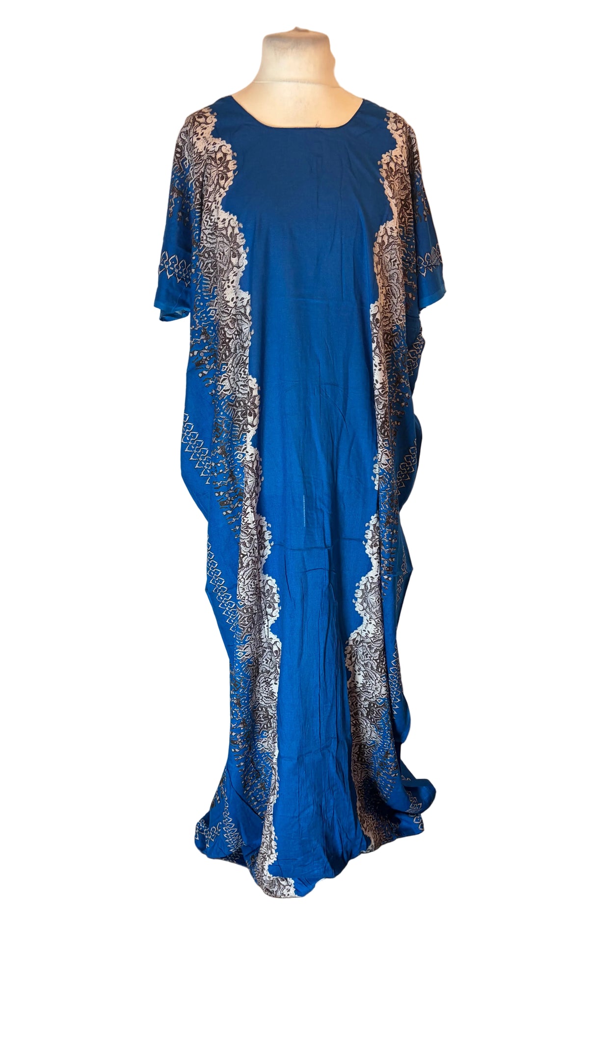 A blue Somali Baati dress with silver patterned side panels displayed on a mannequin in front of a white backdrop.