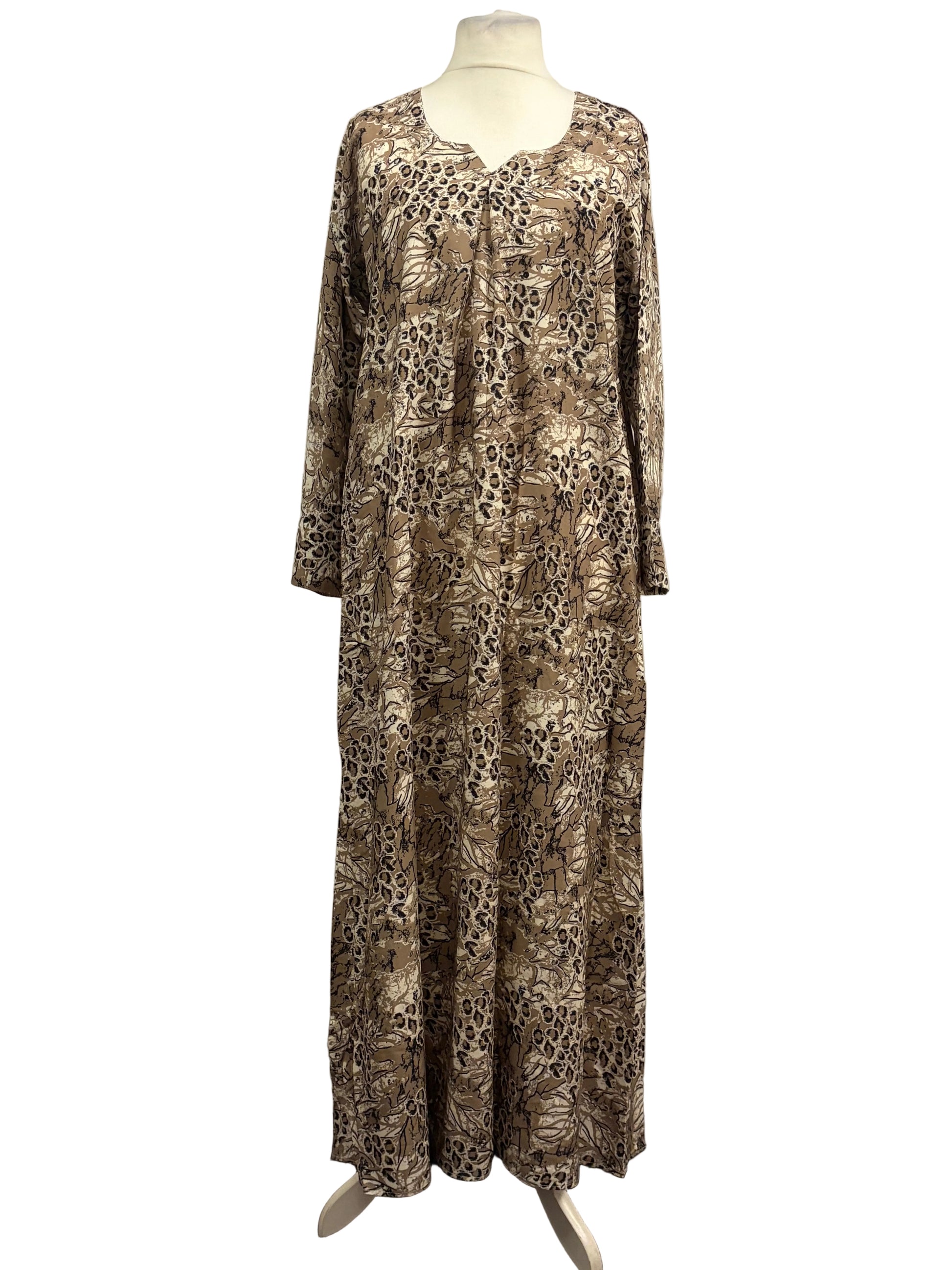 Long patterned dress on a mannequin against a white backdrop