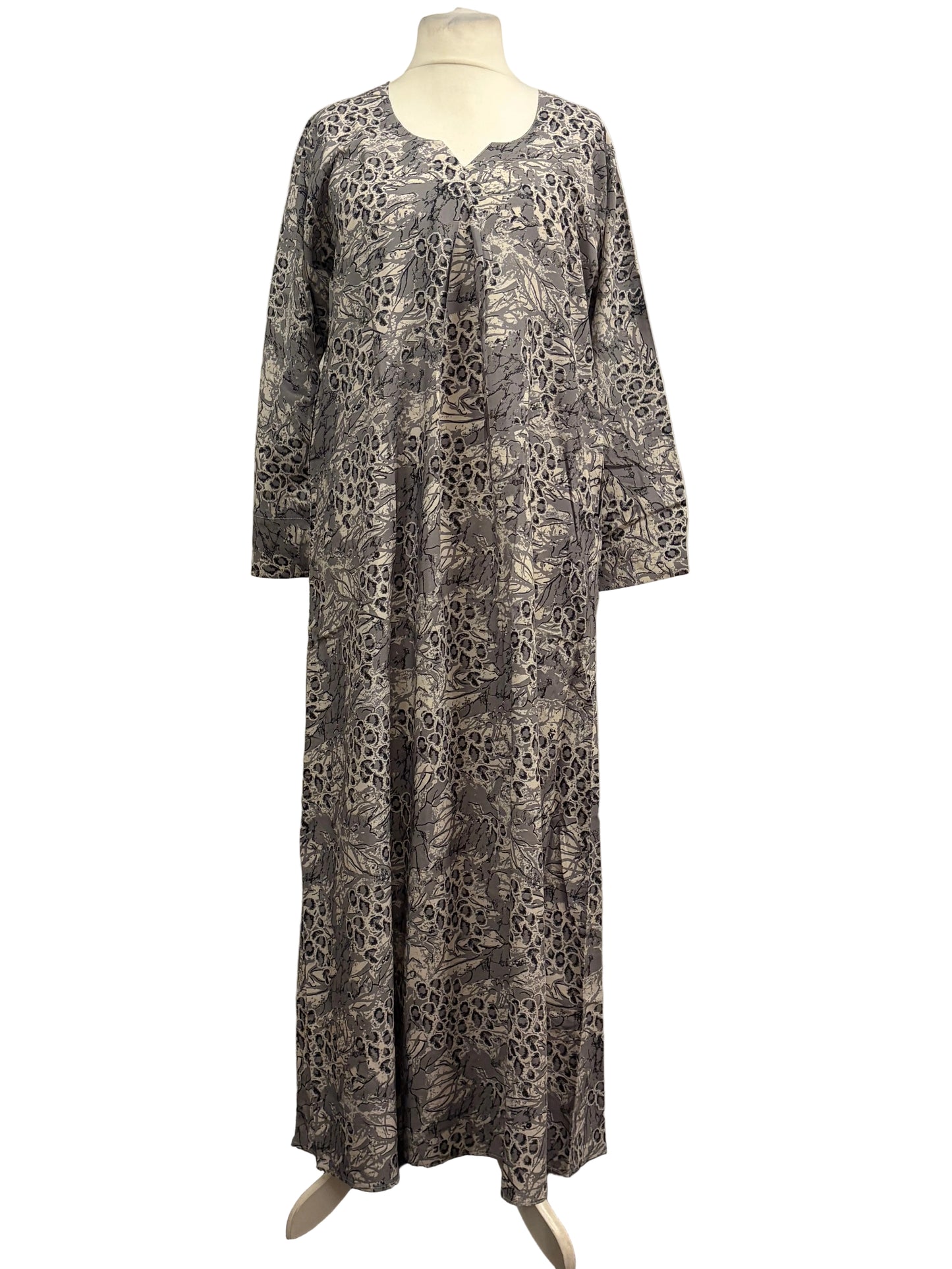 Long patterned dress on a mannequin against a white background