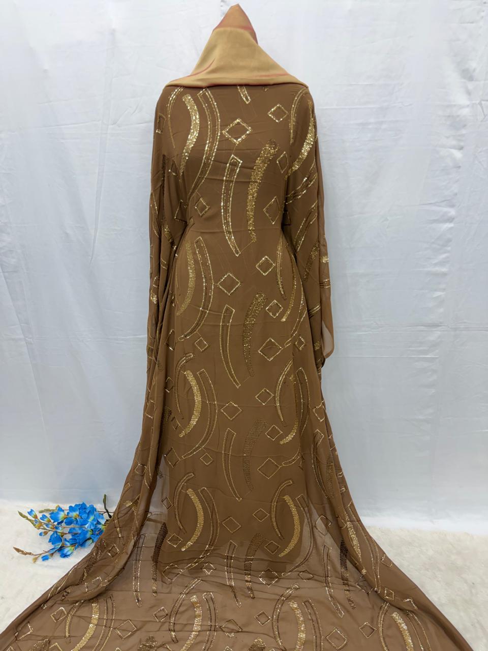 Brown Dirac Maysa fabric with gold patterns on a white background