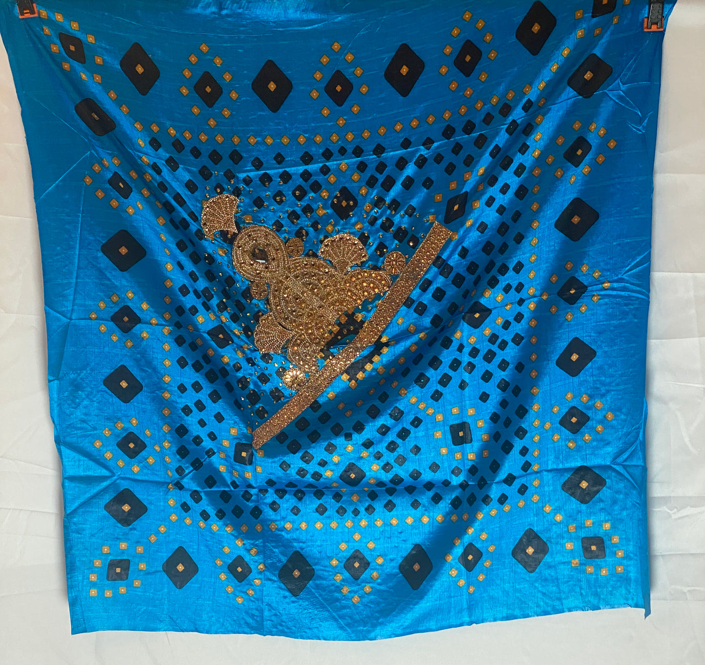 Blue Shaash fabric with black diamond patterns and gold embroidery on a white background