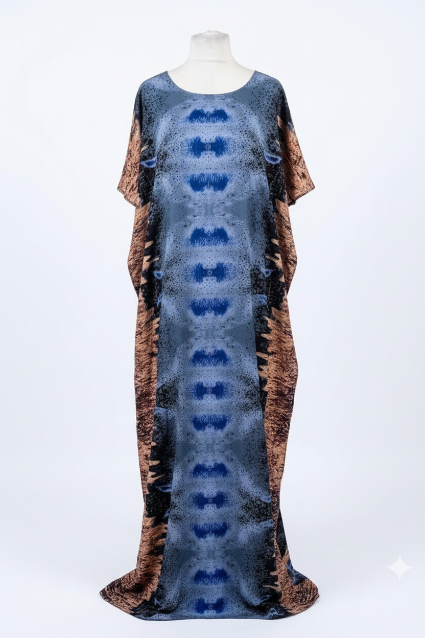 Long Somali baati dress with a pattern on a mannequin against a white background