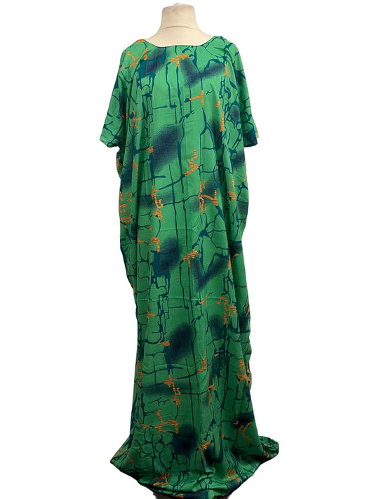 Green dress with abstract pattern on a mannequin against a white background