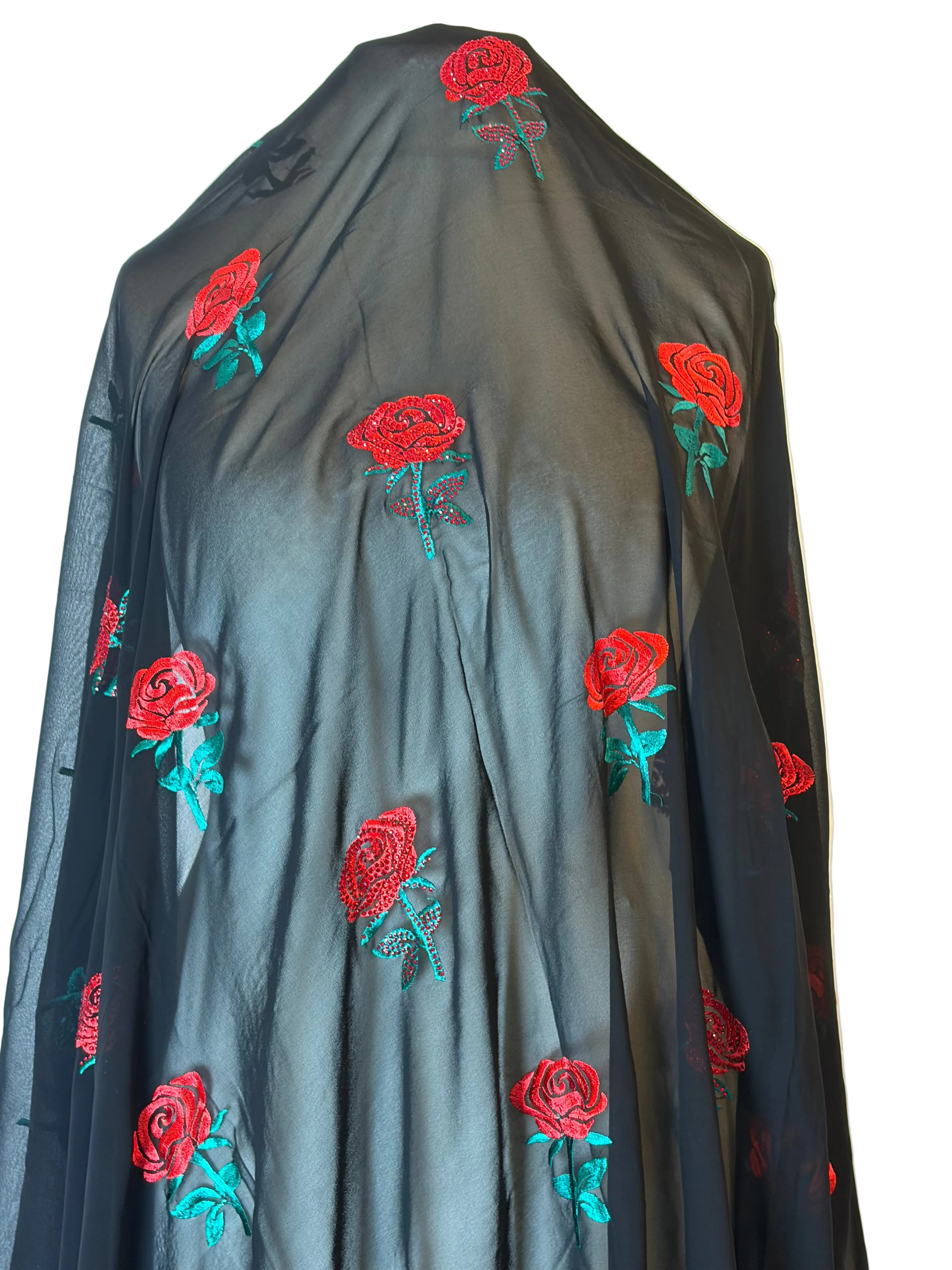 Black fabric with red rose embroidery on a white background