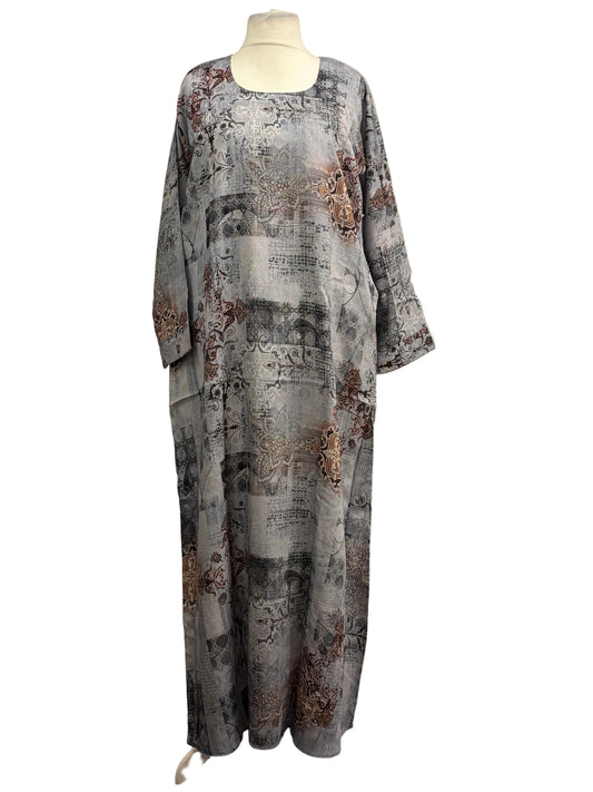 Mannequin wearing a distressed gray dress with rust-like patterns against a white background