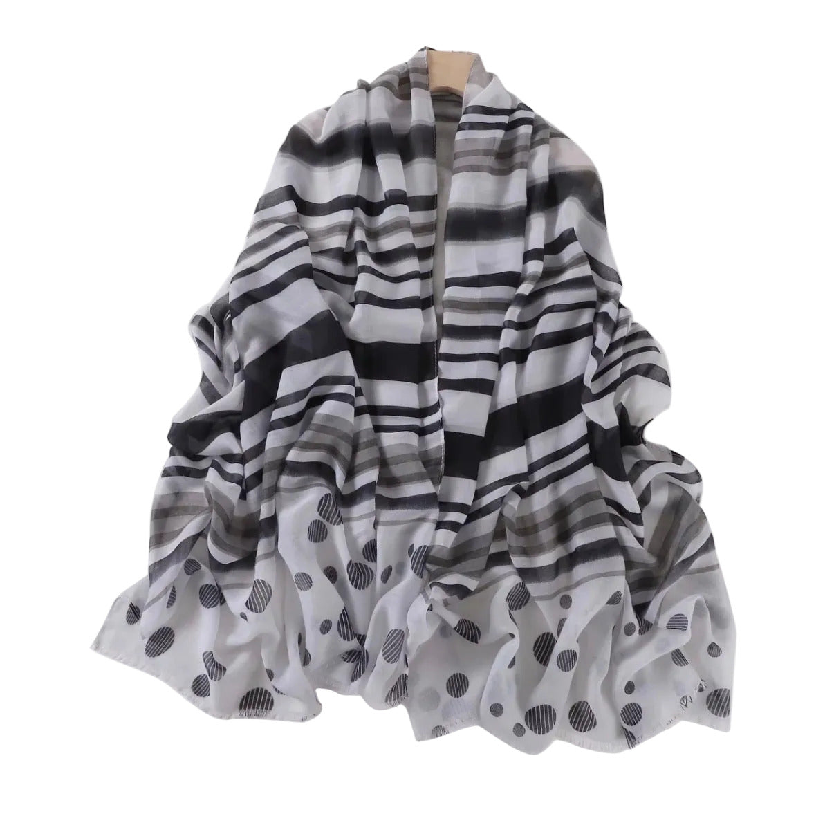 Black and white patterned scarf on a mannequin against a white background