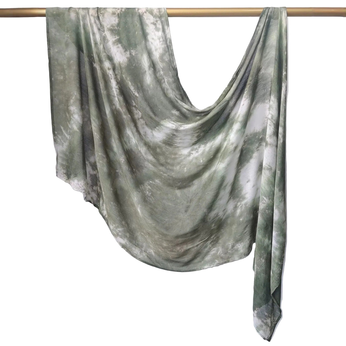 A lightweight, semi-sheer scarf with a green and white tie-dye pattern, draped over a wooden hanger against a white paneled wall.