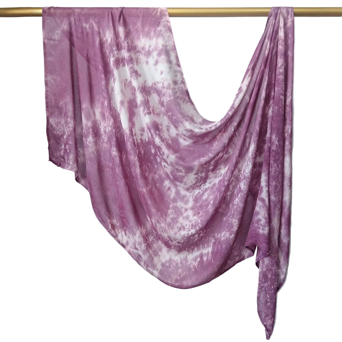 A lightweight fabric scarf or shawl with a purple and white tie-dye pattern, draped over a gold-colored horizontal rod against a white paneled wall.