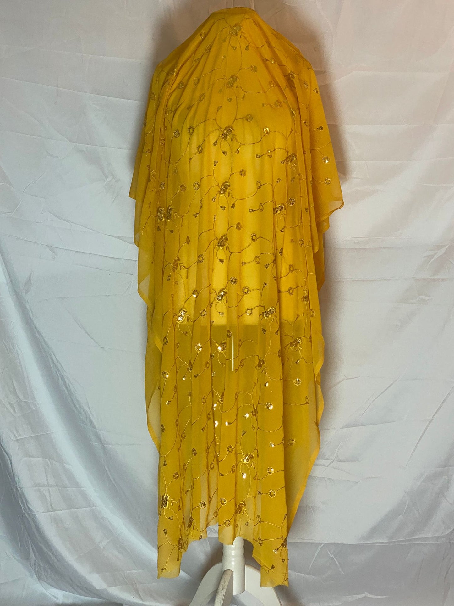 Yellow Somali Garabasaar with floral patterns on a white background
