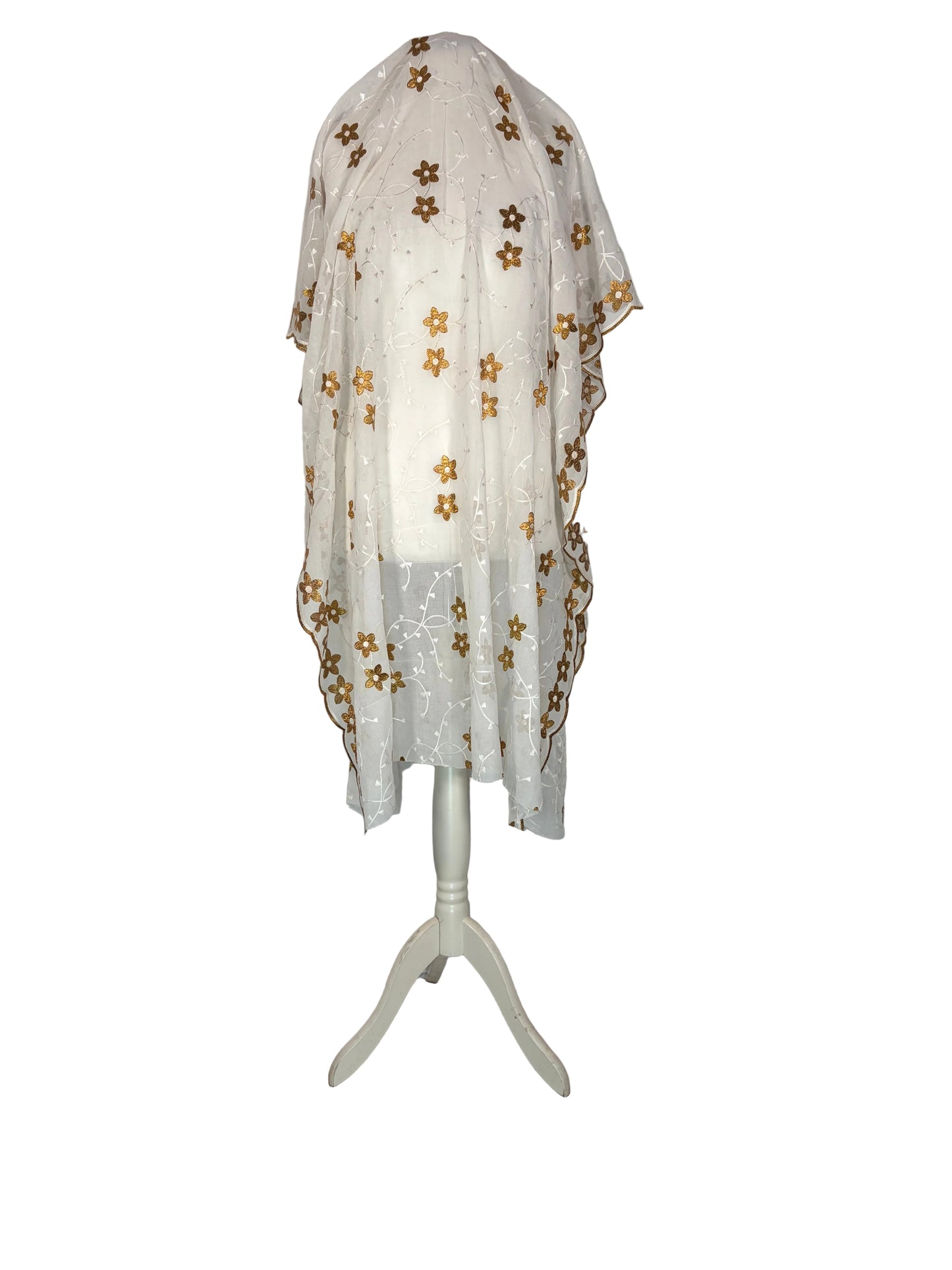 Unstitched White Garbasaar with gold floral patterns on a white surface