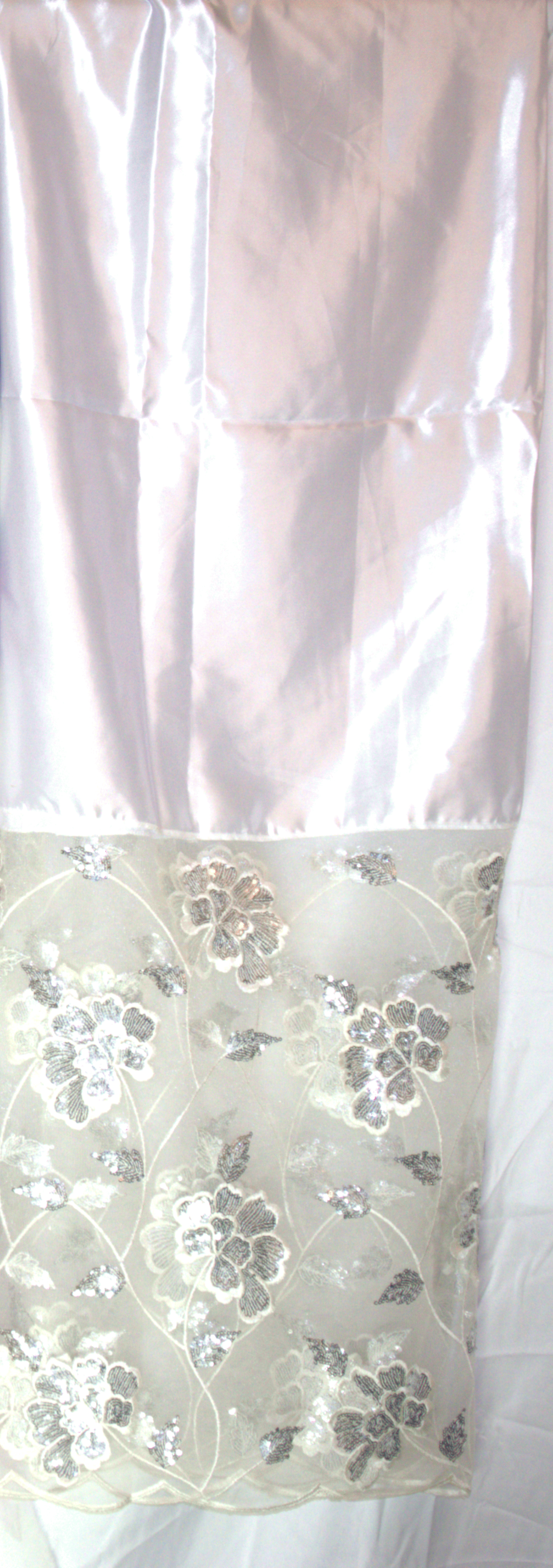 White Gorgorad with floral lace overlay on a white background