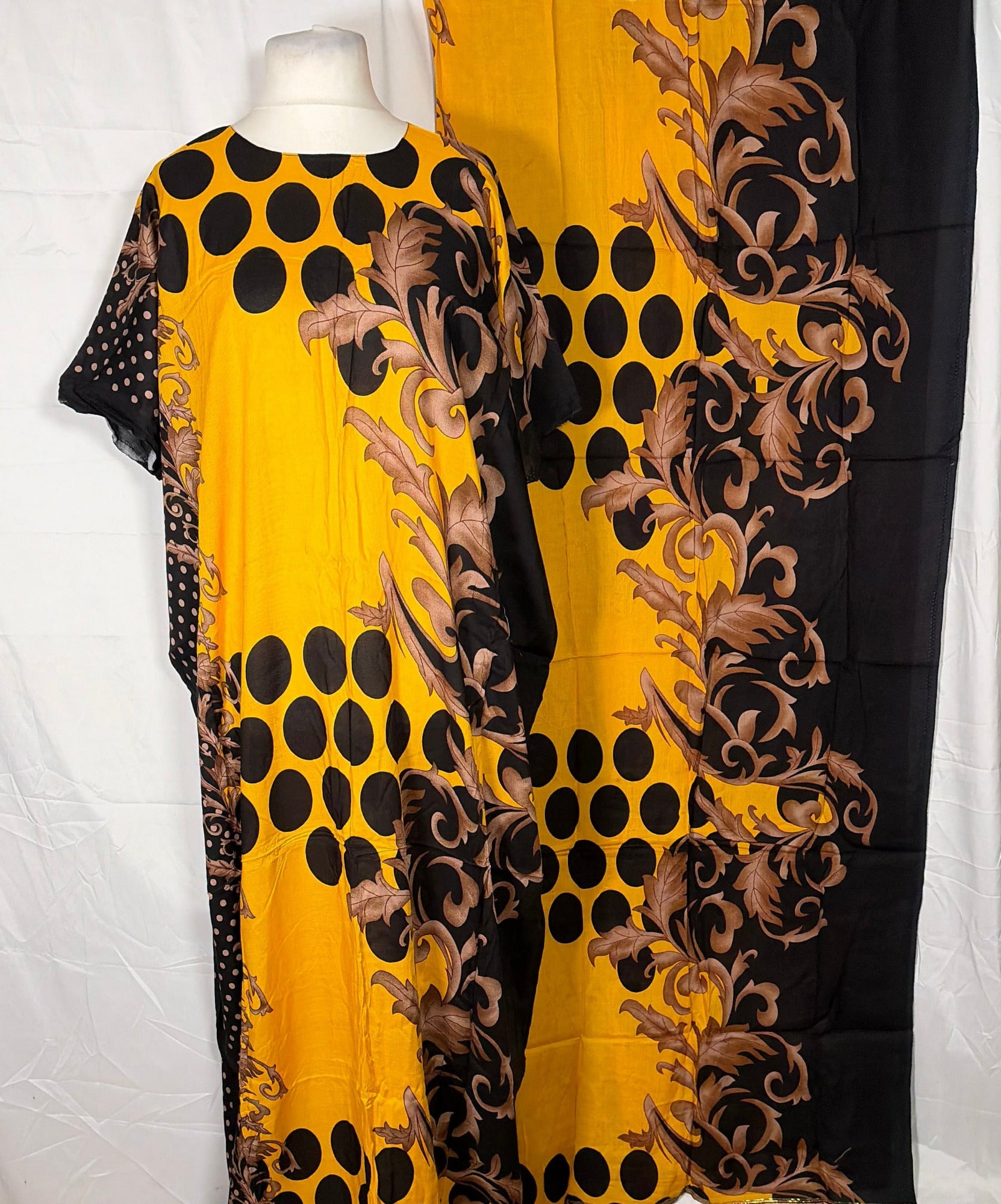 Yellow and black patterned fabric draped over a white surface