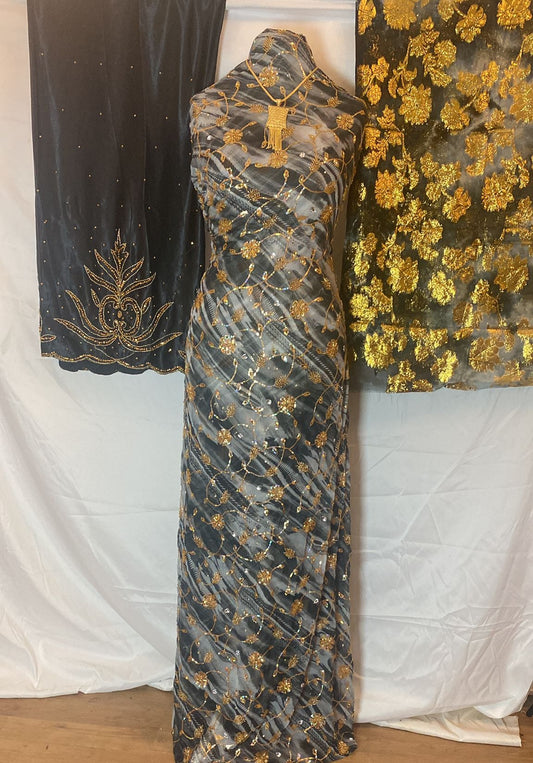 Black Somali Dirac with gold embroidery against a white background