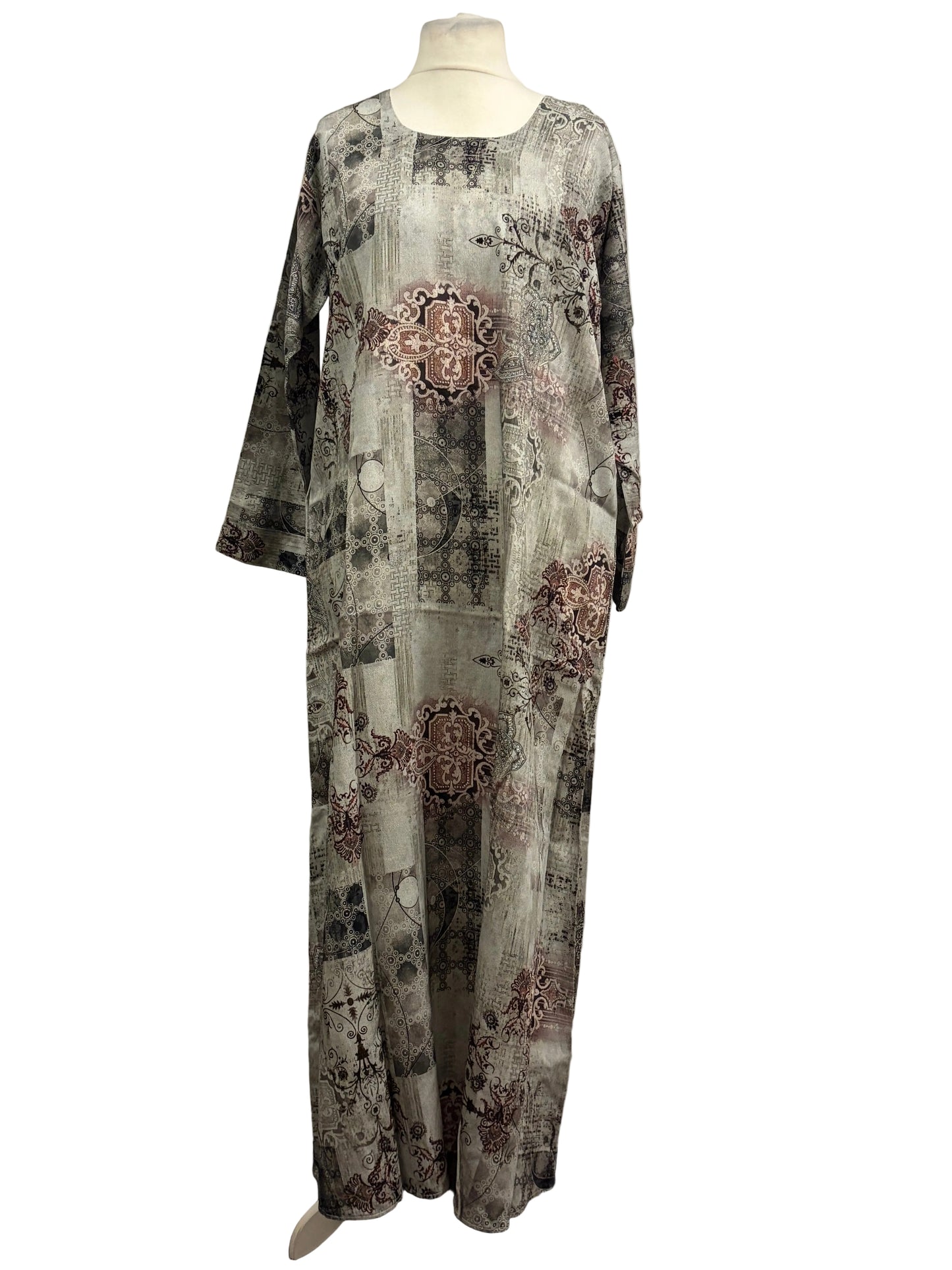 Long-sleeve top with floral patterns on a mannequin against a textured white background