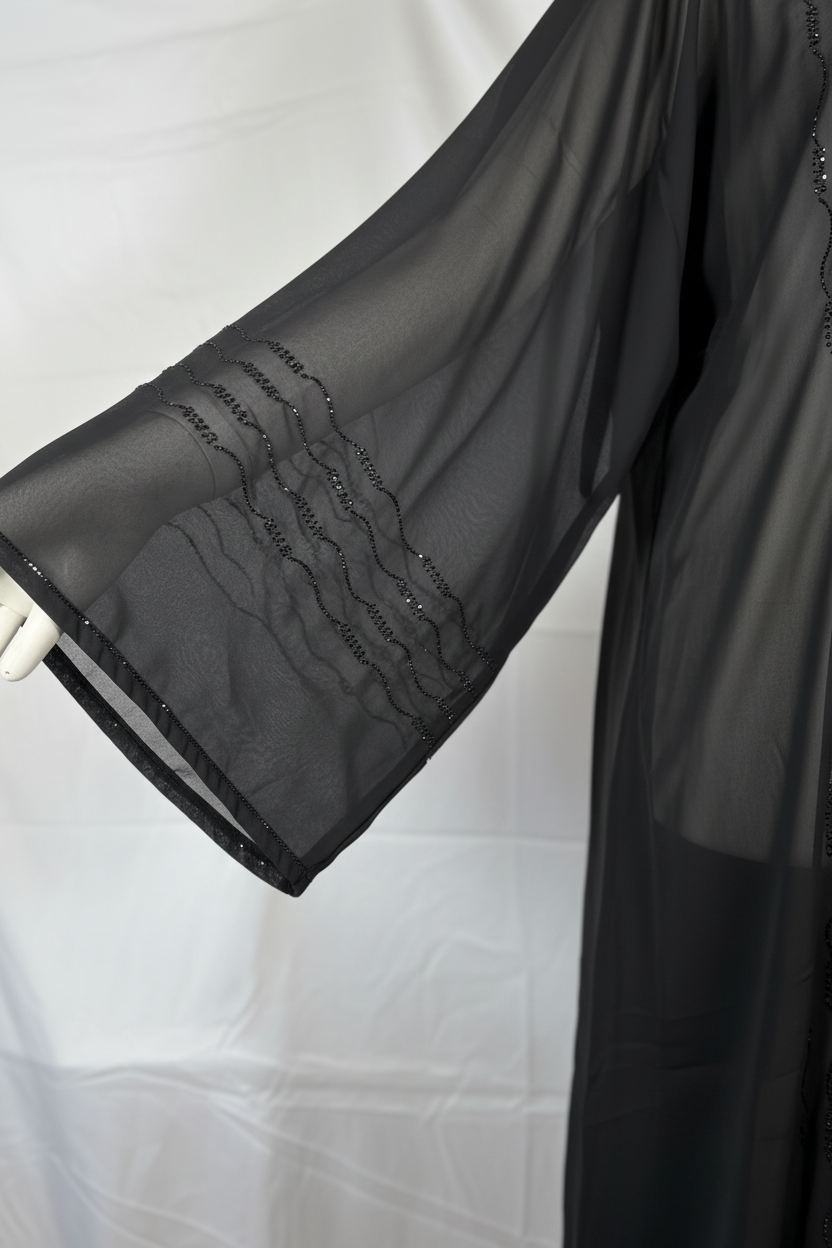 Black chiffon abaya sleeve detail showing triple wave bead embroidery at cuff