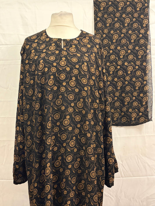 Black fabric with gold paisley pattern on a white background