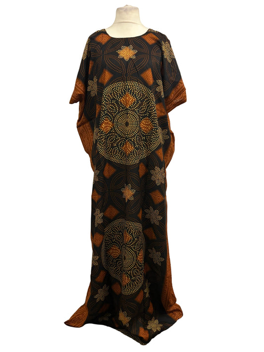 Black and orange patterned dress on a mannequin against a white background