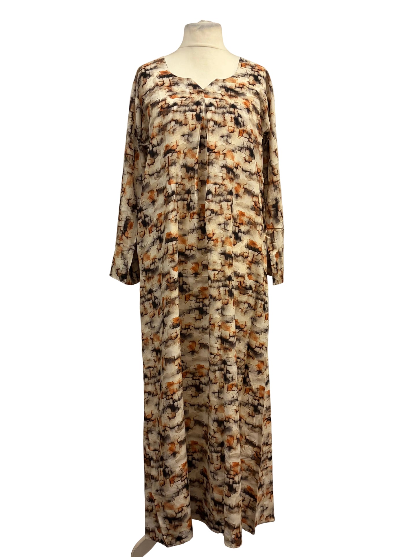 Long-sleeve dress with a pattern on a mannequin against a white backdrop